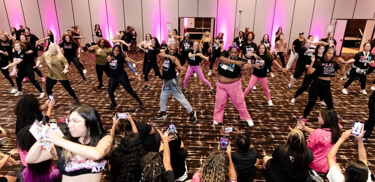 A packed ballroom hitting the same move together